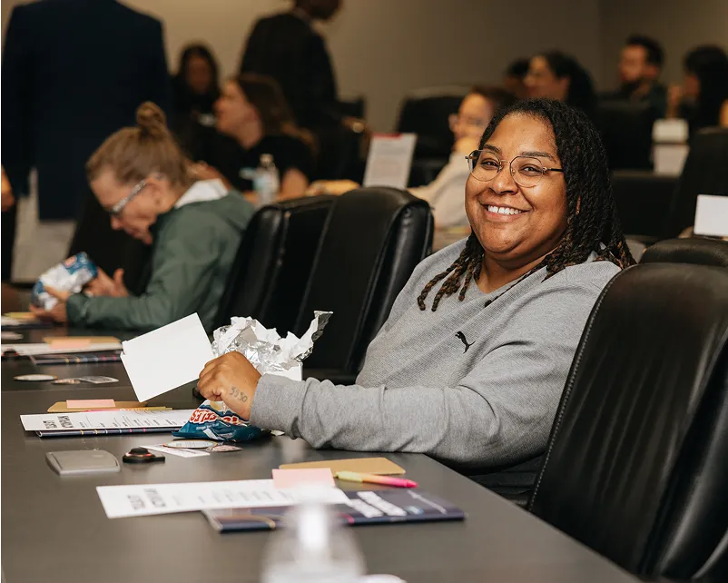 Woman smiling at a conference table